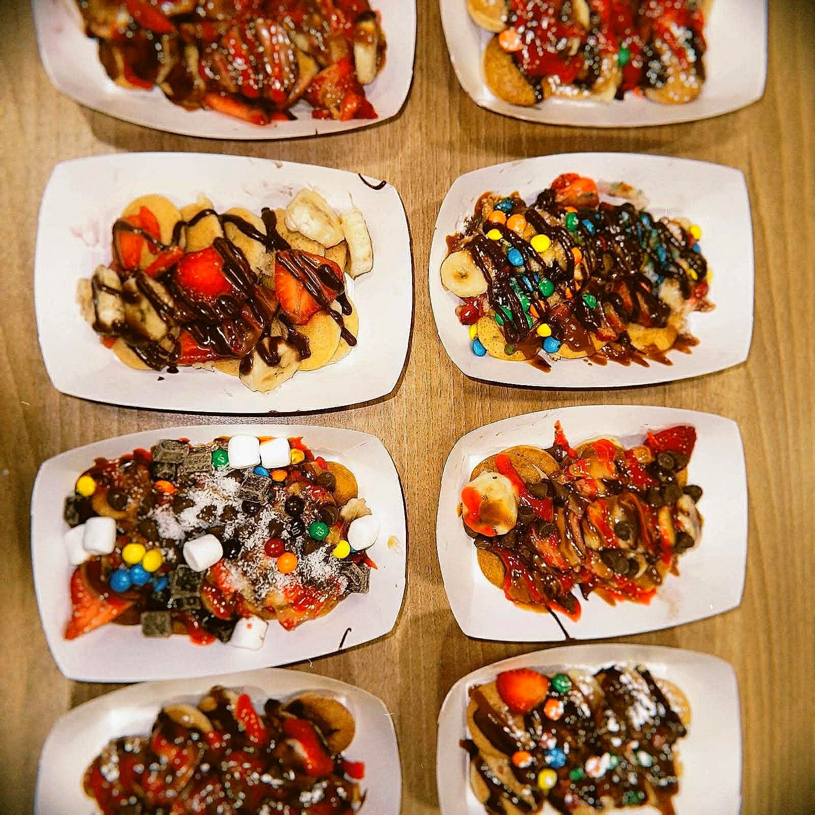 Mini pancake plates with chocolate, fruits and toppings at an Alhana event