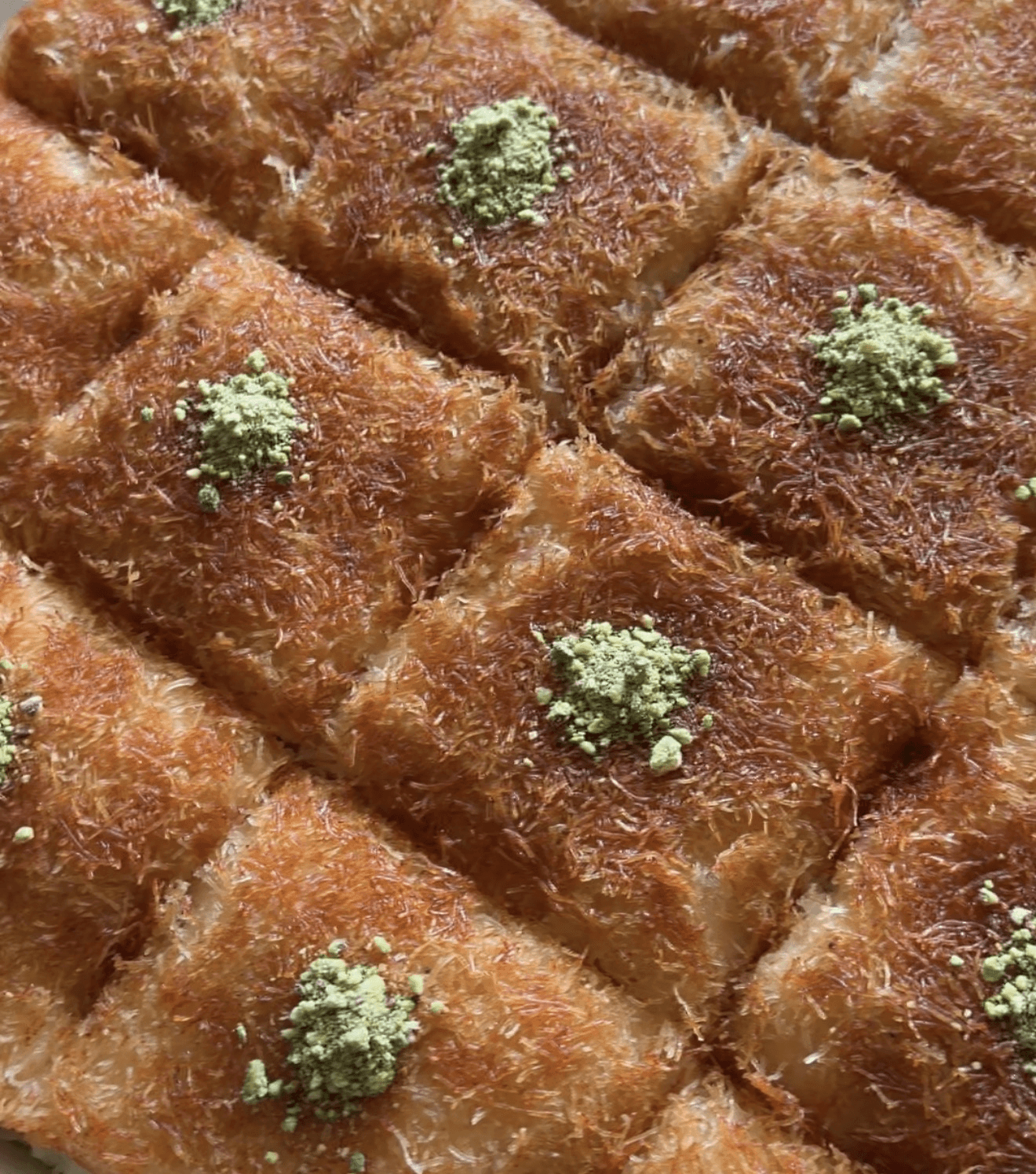Crispy golden kunafa squares topped with pistachios